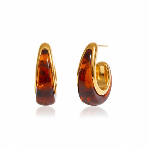 Lyza Jewels, LLC amber-toned acrylic hoop earrings with gold-tone stainless steel posts. Tapered silhouette with marbled finish.