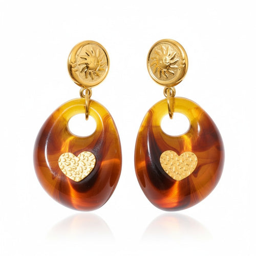 Lyza Jewels, LLC amber resin drop earrings with gold heart detail and sun coin studs. Hypoallergenic, water-resistant.