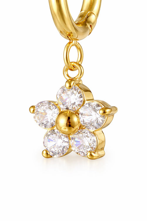 Lyza Jewels, LLC gold stainless steel hoop earrings with a dangling floral charm encrusted with clear cubic zirconia stones.