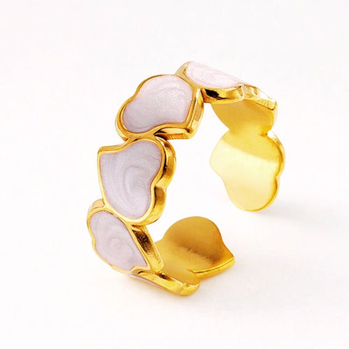 Lyza Jewels, LLC gold stainless steel ring with connected light pink enamel hearts, adjustable band.