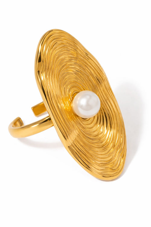Lyza Jewels, LLC gold-tone stainless steel ring with textured oval face and a single white pearl centerpiece.
