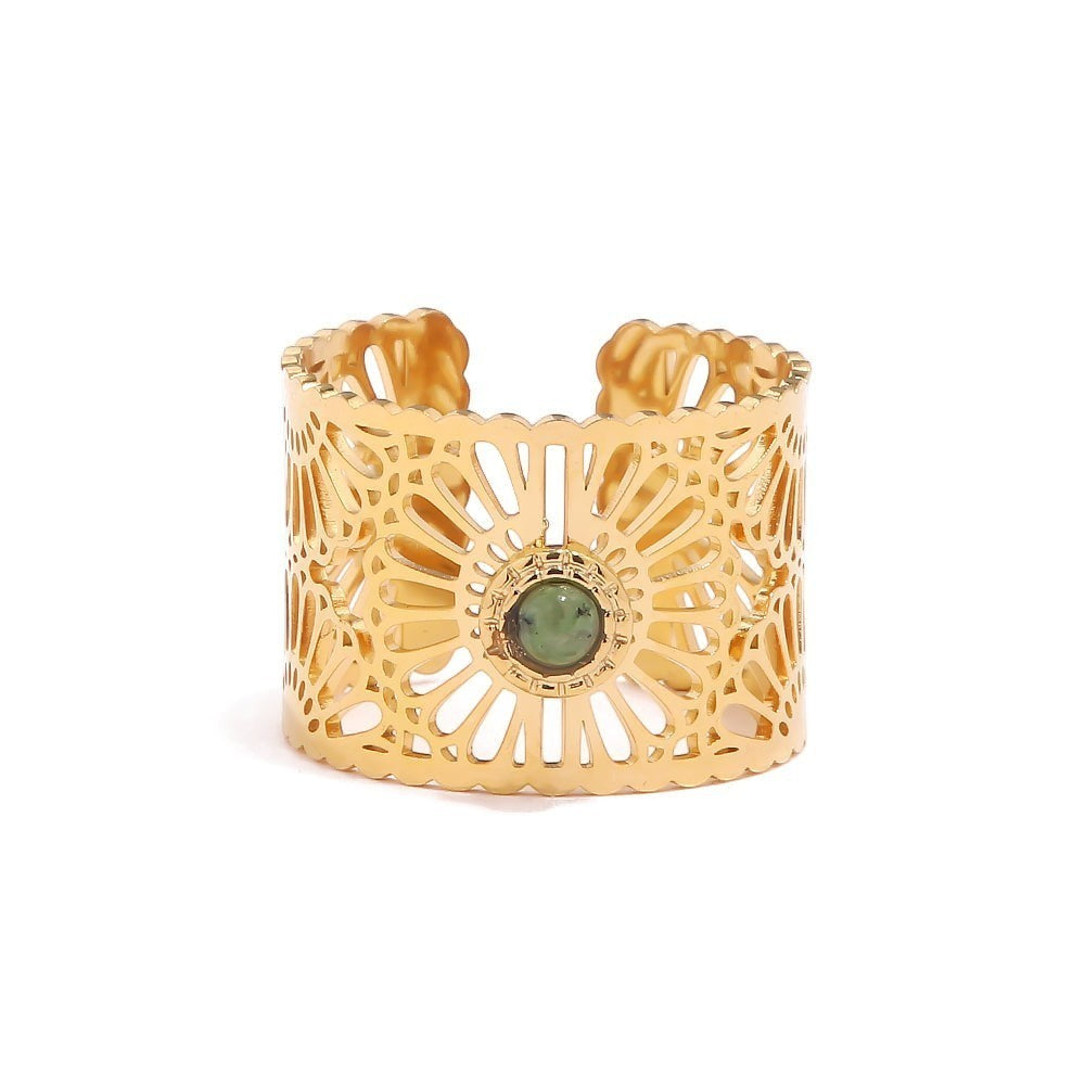 Lyza Jewels, LLC gold stainless steel adjustable ring with intricate cut-out pattern and green stone center.