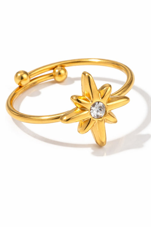 Lyza Jewels, LLC 18k gold plated stainless steel adjustable ring with a star-shaped zirconia centerpiece.