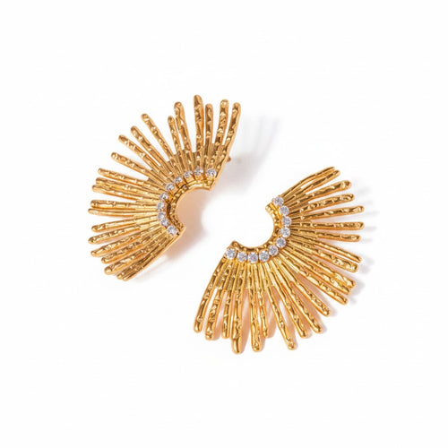 Lyza Jewels, LLC 18k gold stainless steel sunburst earrings with pave diamond accents. Textured rays fan out from a curved center.