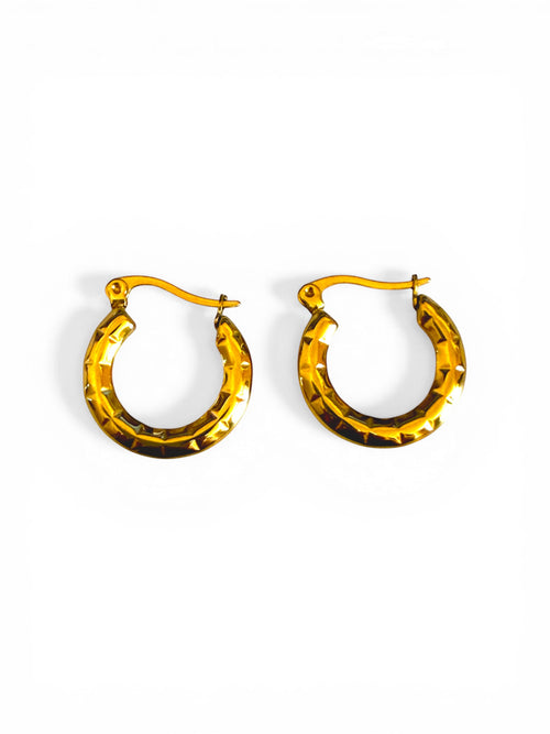 Lyza Jewels, LLC 18K gold textured crescent hoop earrings made of stainless steel with a honeycomb pattern.