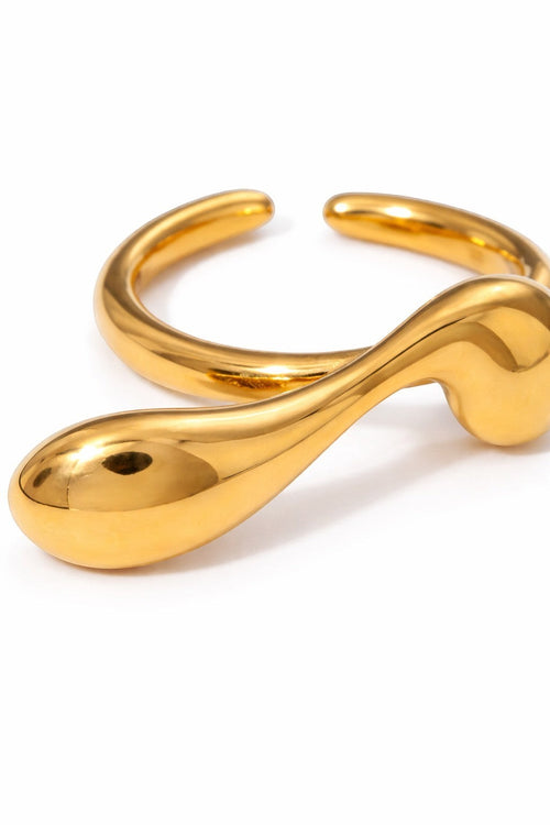 Lyza Jewels, LLC gold stainless steel wavy adjustable ring with a teardrop-shaped end.