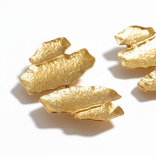 Lyza Jewels, LLC 18K gold-tone stainless steel hammered leaf-shaped statement earrings.