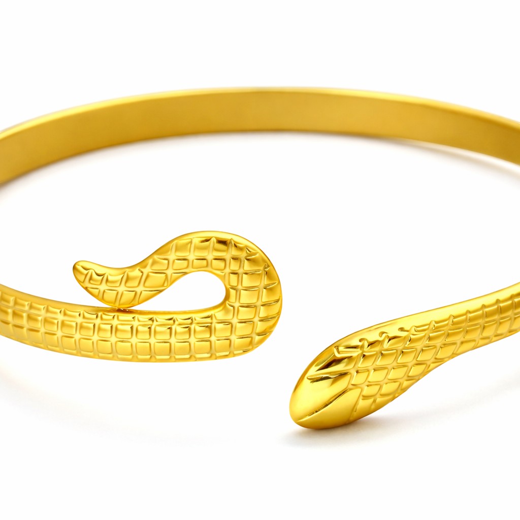 Lyza Jewels, LLC gold-tone serpentine open cuff bracelet with intricate textured snake scale detailing.