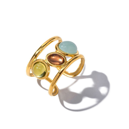 Lyza Jewels, LLC gold adjustable ring with three oval cabochon stones in light blue, copper, and pale green.