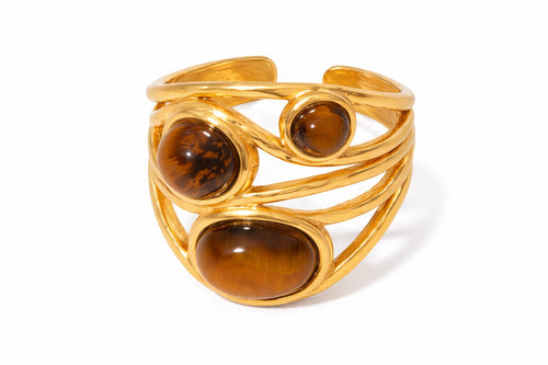 Lyza Jewels, LLC adjustable 18k gold-plated stainless steel ring with three oval tiger's eye stones.