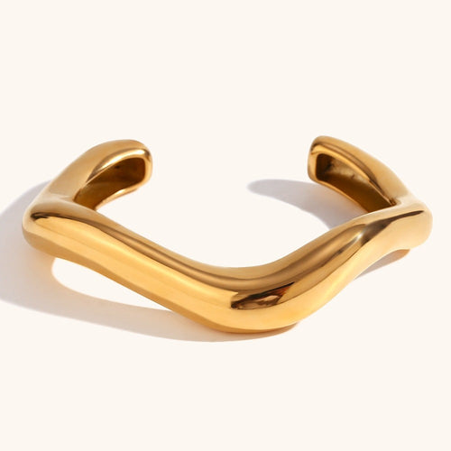Lyza Jewels, LLC gold-tone wavy sculptural cuff bracelet with a high-polish finish and modern minimalist design.